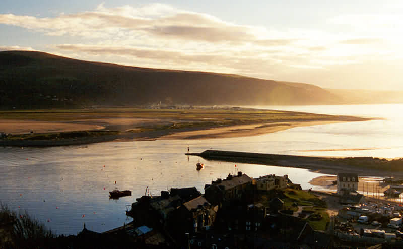 evening view from hill (Dinas Oleu) behind Barmouth over mouth of estuary and Barmouth harbour